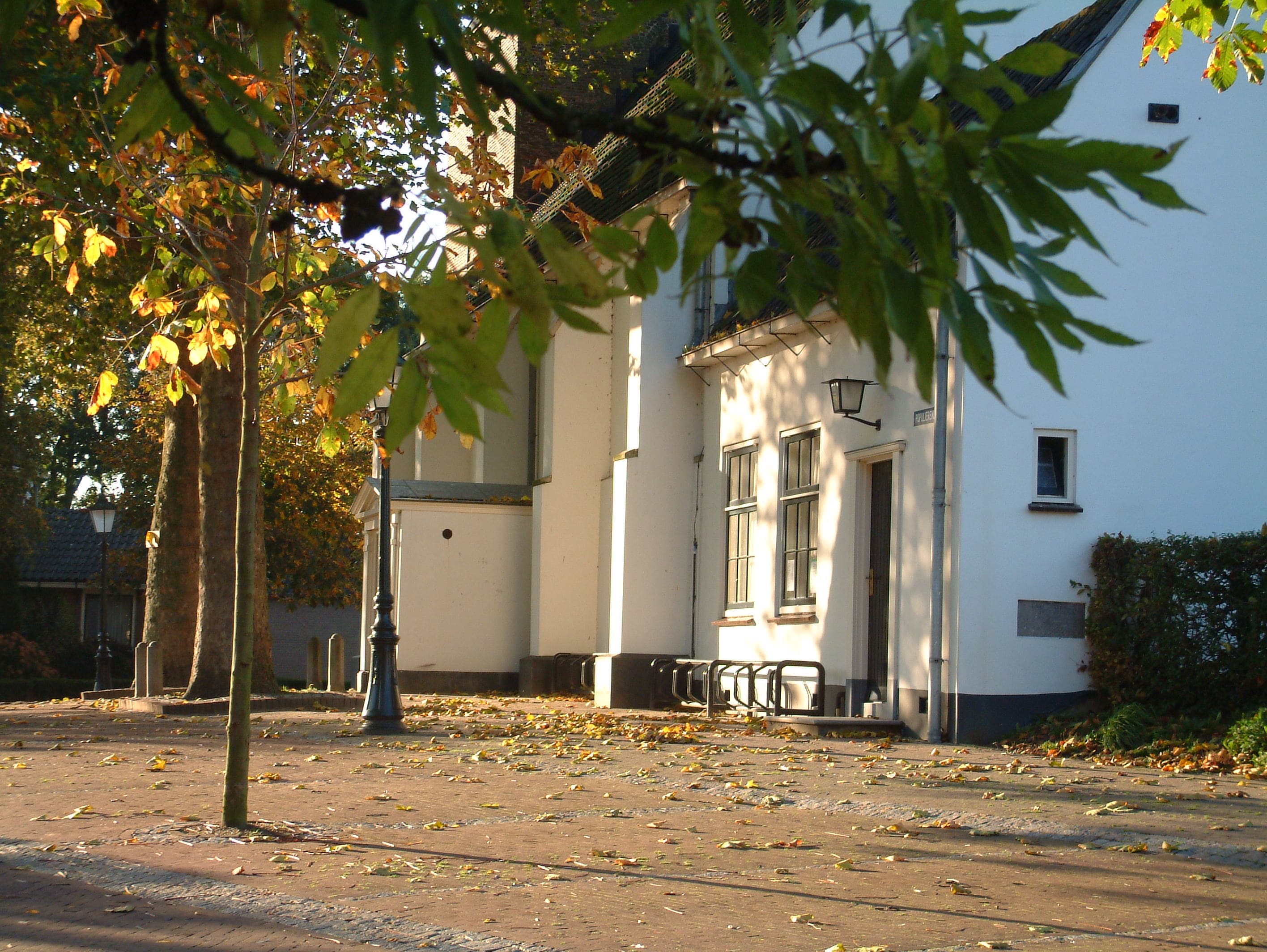 De kerk en De Bron aan de Montignylaan in de herfstzon